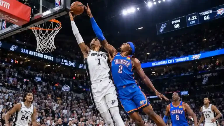San Antonio Spurs player number 1 going up for a contested layup against Oklahoma City Thunder player number 2 in the fourth quarter with Spurs leading 98-96